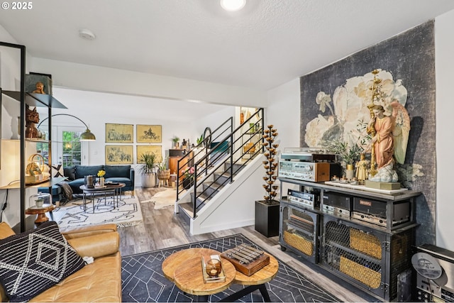 243 Cervantes, Lake Oswego, OR 97035 - living room with stairs, wood finished floors, and an accent wall