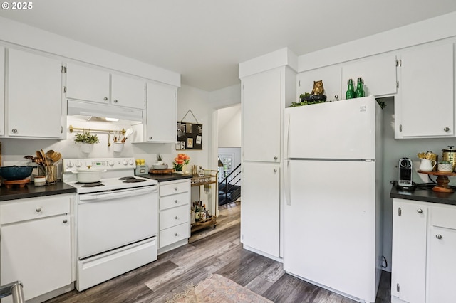 243 Cervantes, Lake Oswego, OR 97035 - kitchen with white appliances, under cabinet range hood, dark countertops, dark wood finished floors, and white cabinets