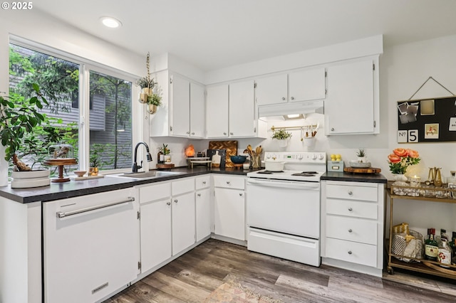 243 Cervantes, Lake Oswego, OR 97035 - kitchen with white appliances, a sink, dark countertops, under cabinet range hood, and white cabinetry