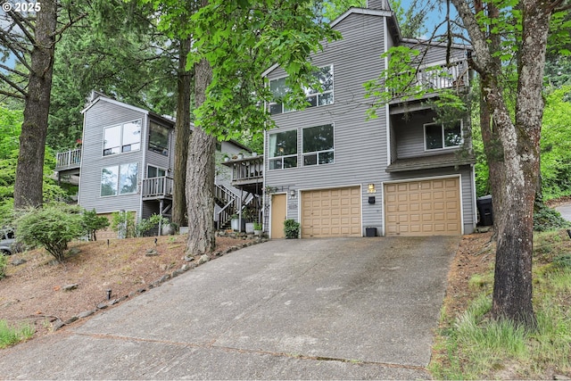 243 Cervantes, Lake Oswego, OR 97035 - view of front of property featuring an attached garage, driveway, stairs, and a balcony
