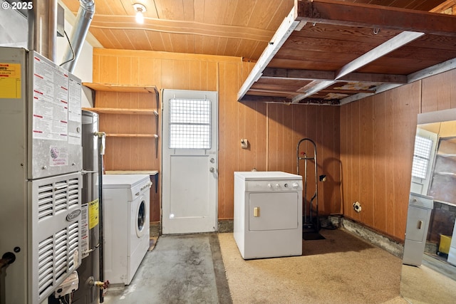 washroom featuring wooden walls, wood ceiling, laundry area, and washer and clothes dryer