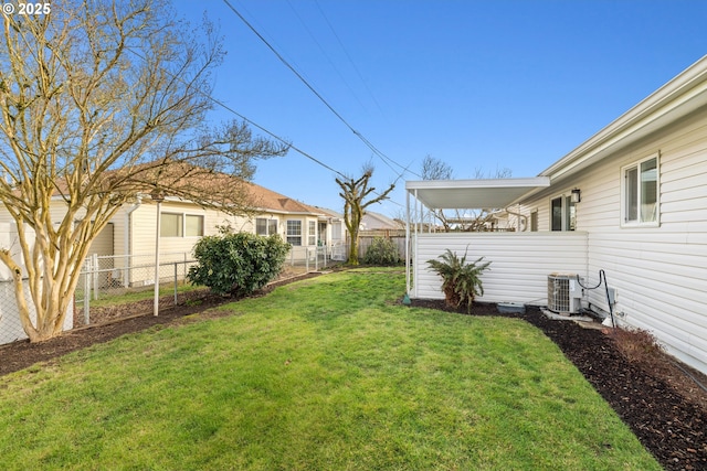 view of yard featuring fence and central AC unit