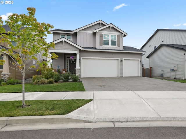 craftsman house featuring a garage and a front lawn