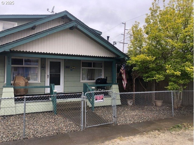 63776 Flanagan Rd, Coos Bay, OR 97420 - view of front facade with a gate, a fenced front yard, and a porch