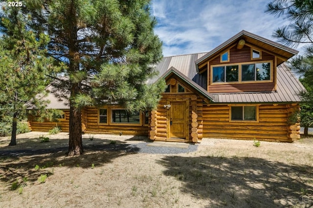 log cabin with log siding and metal roof