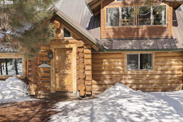 view of side of property featuring metal roof and log siding