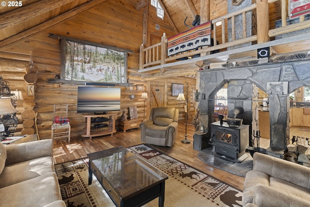 living room with wood ceiling, a wood stove, high vaulted ceiling, beamed ceiling, and hardwood / wood-style flooring