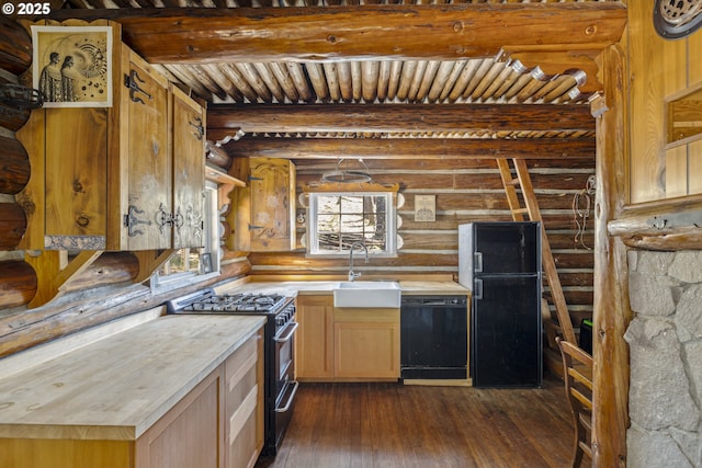 kitchen with black appliances, rustic walls, dark wood-type flooring, light countertops, and a sink
