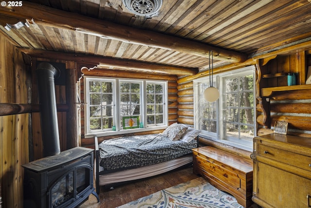 bedroom featuring rustic walls, wooden ceiling, hardwood / wood-style flooring, beamed ceiling, and a wood stove