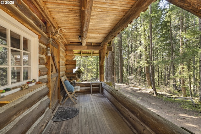 wooden terrace with a view of trees