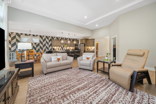 living room with baseboards, light wood finished floors, and recessed lighting