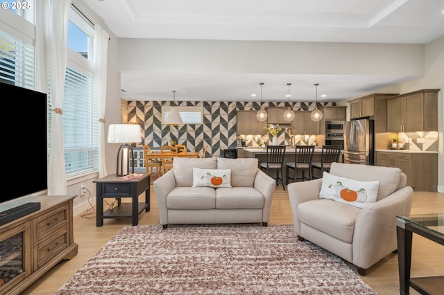 living room with recessed lighting and light wood-style floors