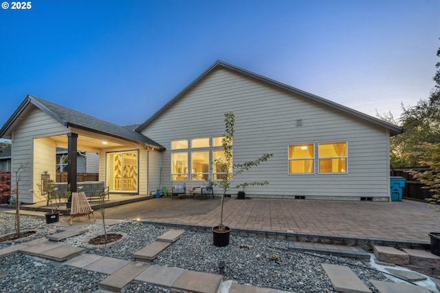 back of property with a patio