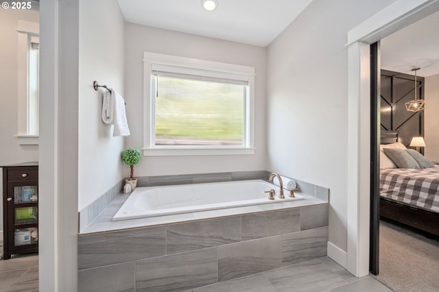 full bathroom featuring a bath and ensuite bath