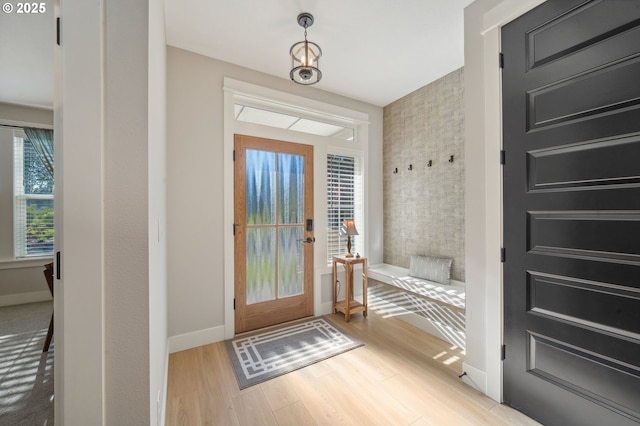 interior space with baseboards and wood finished floors