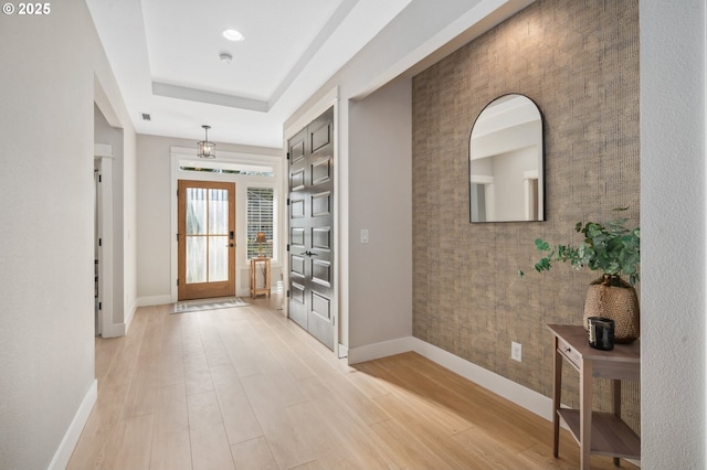 entryway with light wood finished floors and baseboards