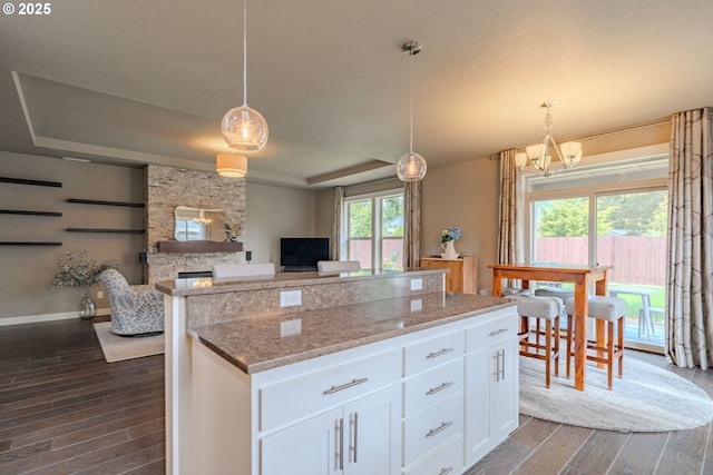 11201 NE 127th Ave, Vancouver, WA 98682 - kitchen featuring a tray ceiling, dark wood-type flooring, white cabinetry, a chandelier, and a kitchen island
