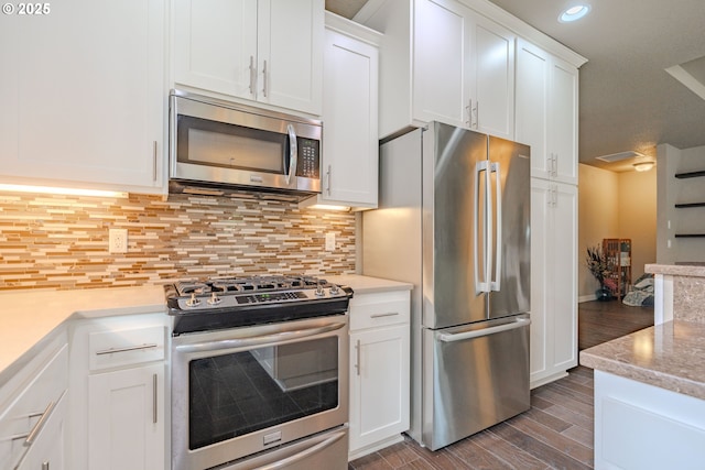 11201 NE 127th Ave, Vancouver, WA 98682 - kitchen featuring appliances with stainless steel finishes, wood finished floors, white cabinetry, backsplash, and recessed lighting