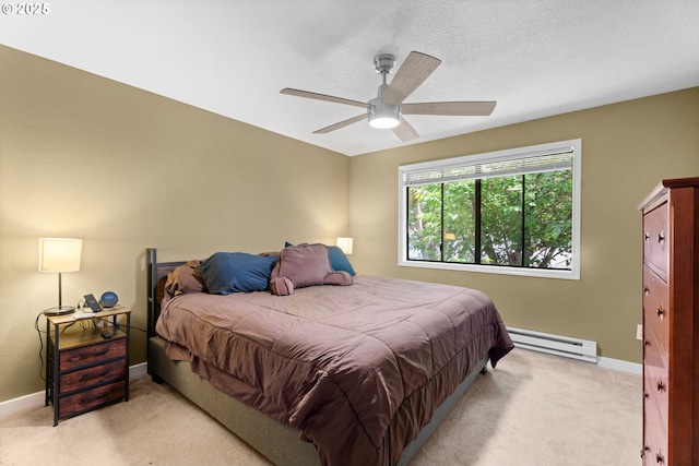 bedroom with a baseboard radiator, light colored carpet, baseboards, and a ceiling fan