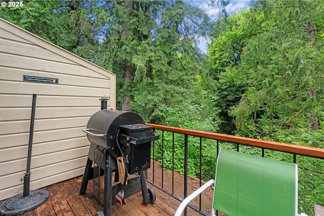 wooden deck with a grill