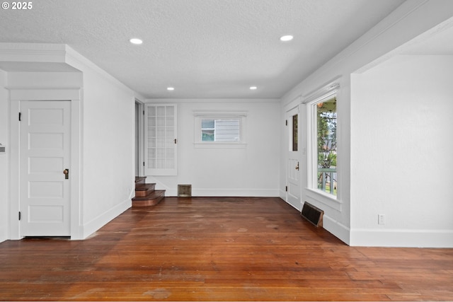 322 W C St, Rainier, OR 97048 - empty room with a textured ceiling, wood-type flooring, recessed lighting, and stairs