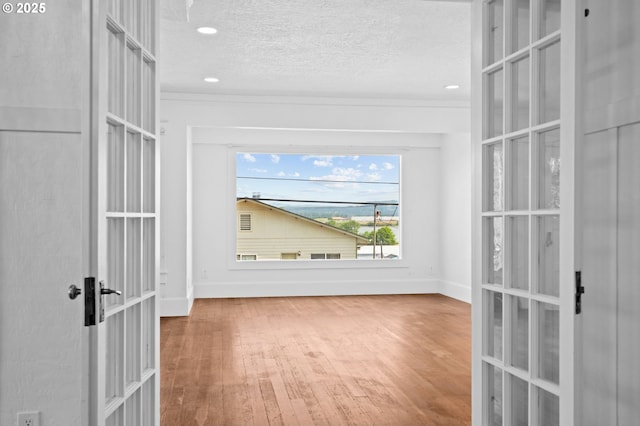 322 W C St, Rainier, OR 97048 - unfurnished room featuring french doors, wood finished floors, a textured ceiling, ornamental molding, and recessed lighting