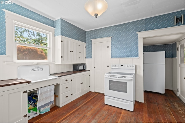 322 W C St, Rainier, OR 97048 - kitchen with white appliances, wallpapered walls, a wainscoted wall, ornamental molding, and dark wood-style floors