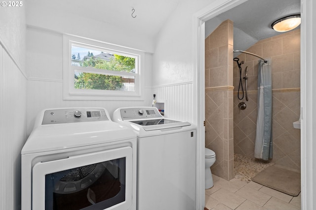 322 W C St, Rainier, OR 97048 - washroom featuring washer and dryer, light tile patterned floors, and a wainscoted wall
