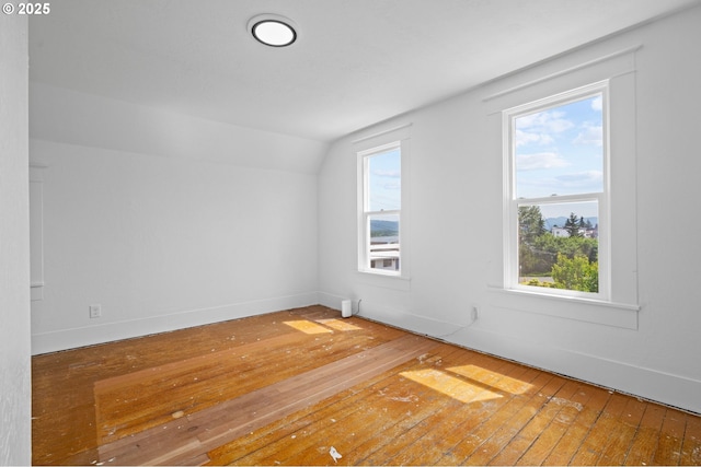 322 W C St, Rainier, OR 97048 - empty room with hardwood / wood-style floors, vaulted ceiling, and plenty of natural light