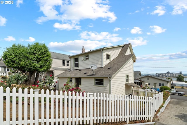 322 W C St, Rainier, OR 97048 - rear view of house featuring roof with shingles and a chimney