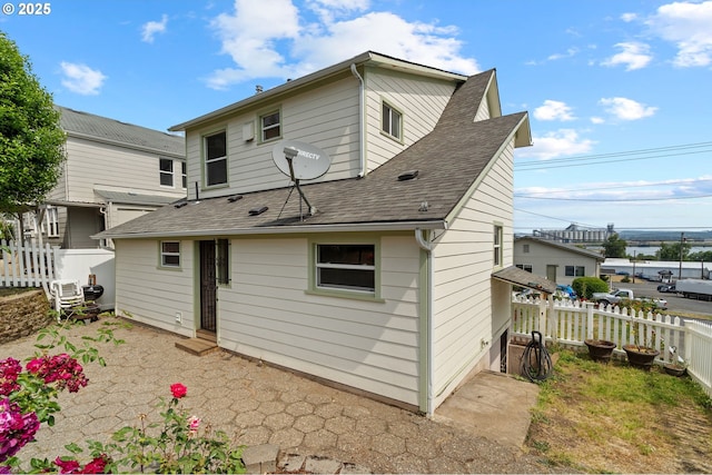 322 W C St, Rainier, OR 97048 - rear view of property featuring roof with shingles and entry steps