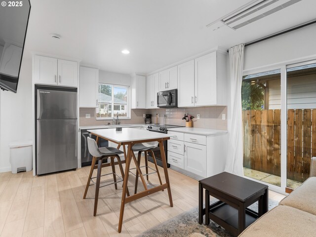 spare room with light hardwood / wood-style floors