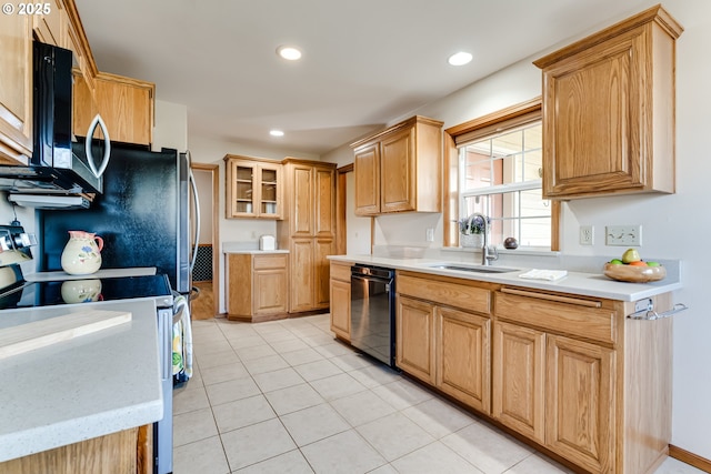 kitchen with a sink, black dishwasher, light countertops, electric range oven, and stainless steel microwave