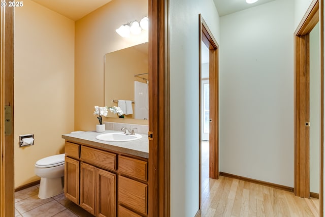 full bathroom featuring baseboards, toilet, wood finished floors, walk in shower, and vanity