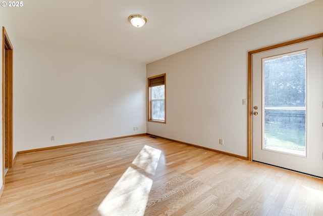 unfurnished room featuring light wood-style flooring and baseboards