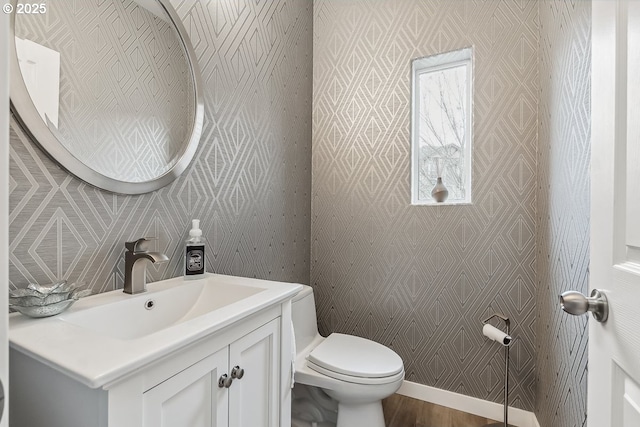 bathroom featuring vanity, hardwood / wood-style floors, and toilet