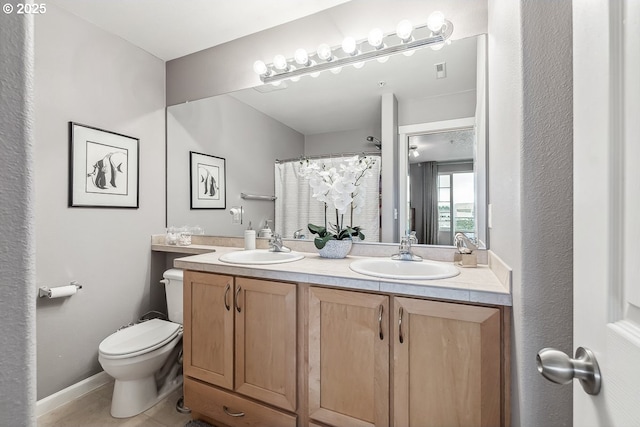 bathroom with a shower with curtain, vanity, toilet, and tile patterned flooring