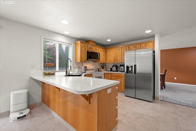 11716 NE 42nd Ct, Vancouver, WA 98686 - kitchen with appliances with stainless steel finishes, a peninsula, a sink, light countertops, and recessed lighting