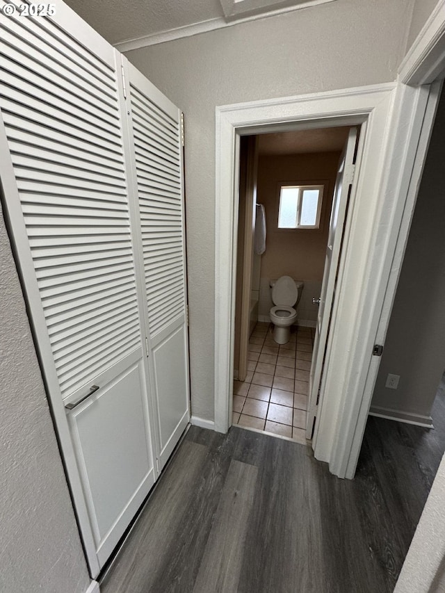 hall featuring ornamental molding and dark hardwood / wood-style flooring