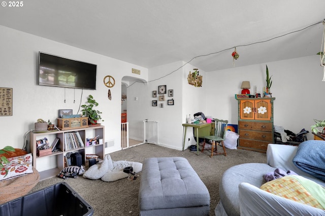 carpeted living room with arched walkways and visible vents