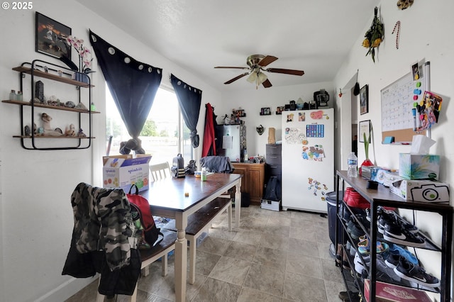 dining area featuring a ceiling fan and baseboards