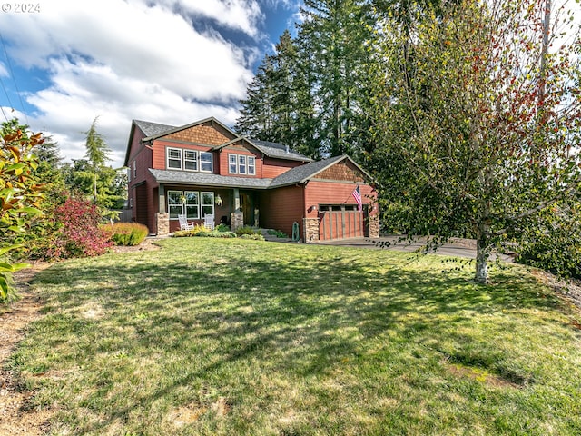 view of front of property with a garage and a front lawn