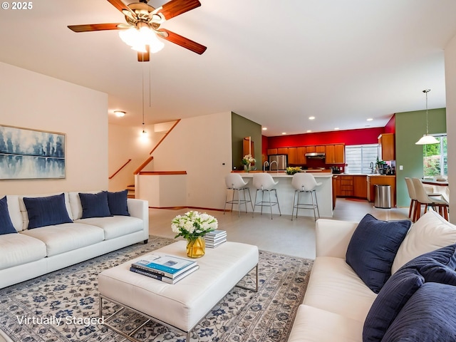 living area featuring recessed lighting, stairway, and ceiling fan