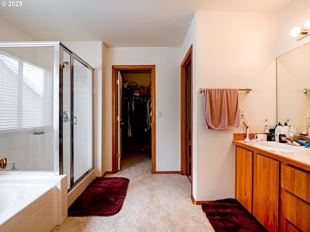 full bathroom with vanity, a spacious closet, tiled bath, carpet floors, and a shower stall