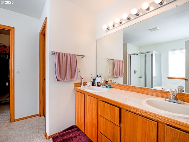 full bathroom featuring a shower stall, double vanity, visible vents, and a sink