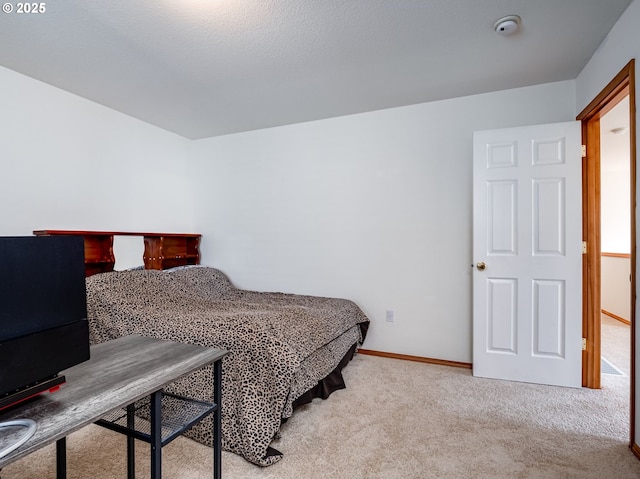 bedroom featuring carpet floors and baseboards