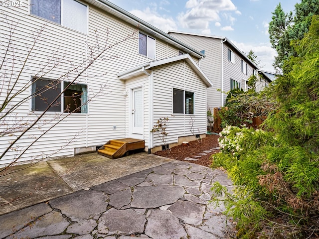 rear view of property featuring a patio area and fence