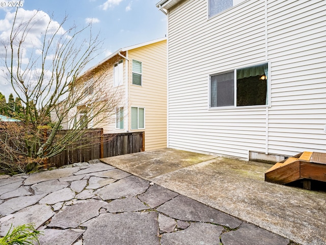 rear view of house with a patio and fence