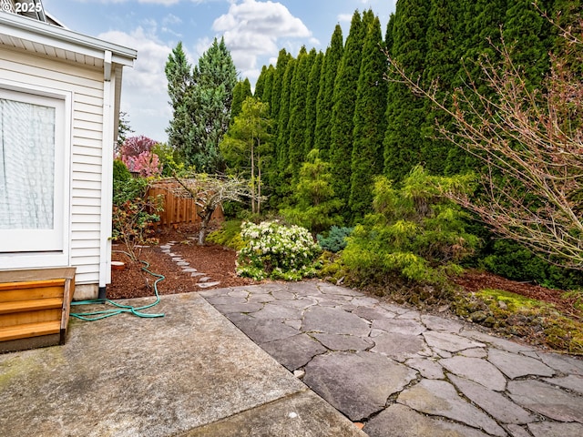 view of patio featuring entry steps and fence