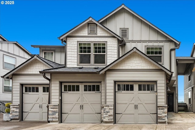 9183 NW Germantown Rd, Portland, OR 97231 - craftsman-style house featuring an attached garage, board and batten siding, concrete driveway, and stone siding